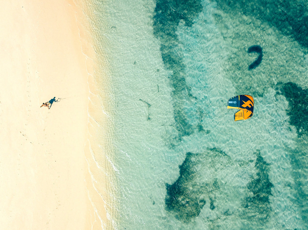 Kitesurfer in der türkisen Bucht von Sa Marina bei Alcúdia aus der Luft
